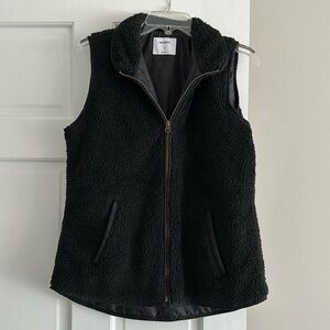 Black vest with gold zipper